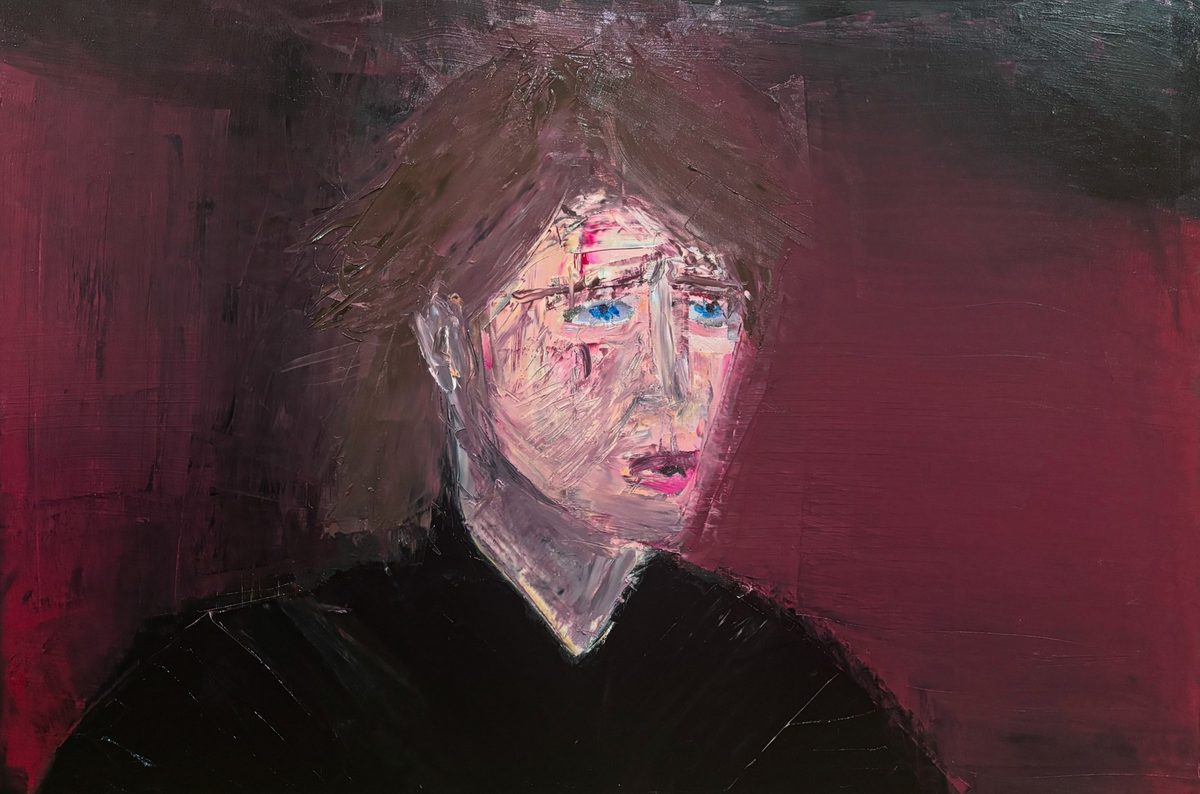 Sensitive Young Fascist - A pale, worried face with blue eyes and messy hair is set against a deep burgundy background and black shirt.